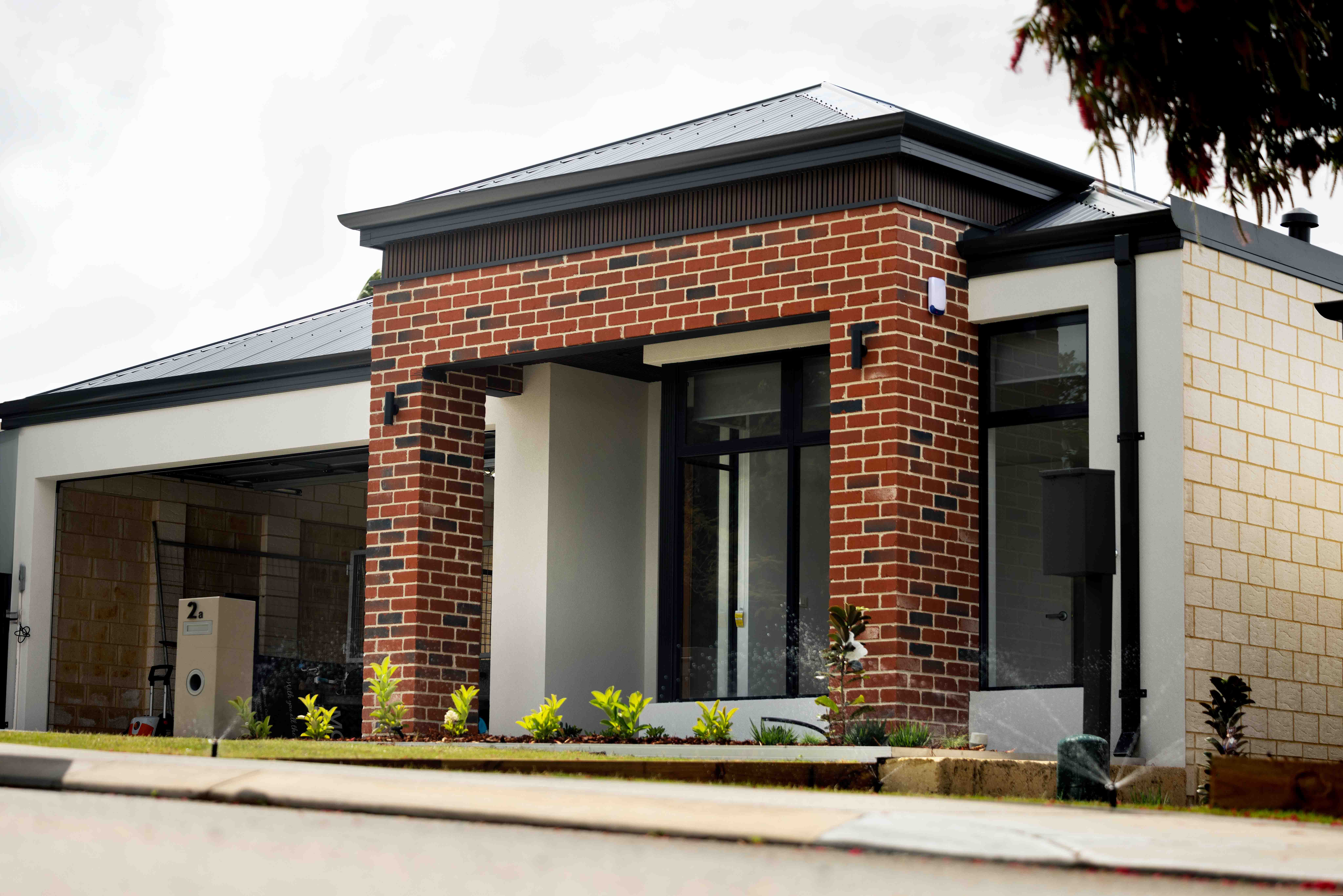Front of red brick SDA home